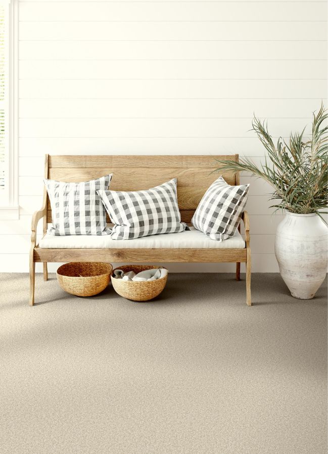 durable textured carpets in an entryway with a bench